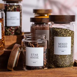 Close-up detail of clear glass spice jars with premium acacia wood lids and labels