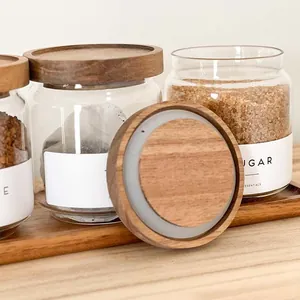 Detail shot of airtight glass storage jars showing natural acacia wood lid and seal