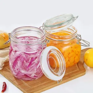 Clear glass jars with airtight wire-top lids used for pickled onions and food storage