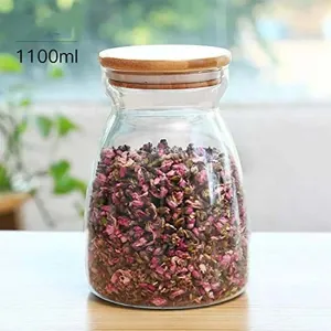 Close-up detail of 1100ml glass storage jar with airtight bamboo lid and flower tea