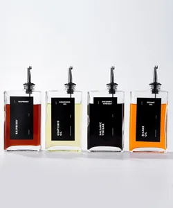 Set of four square glass oil and vinegar dispensers with black labels and pourers