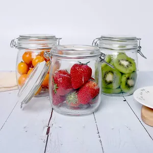 Hermetic transparent glass storage jars with wire-toggle clamps filled with fresh fruits