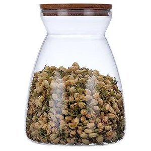 Close-up of a trapezoidal glass jar with bamboo lid filled with dried jasmine flowers
