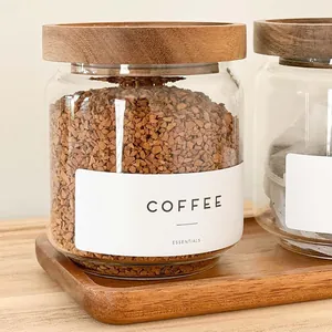 Close-up of a premium glass storage jar featuring an acacia wood lid and coffee label