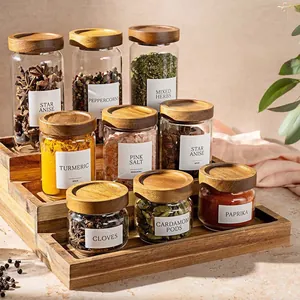 Detailed view of glass spice jars with acacia wood lids on a wooden rack