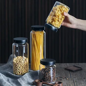 Set of airtight glass storage jars with black pine lids for coffee beans and pasta storage