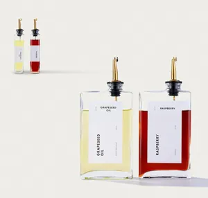 Modern flat glass oil dispenser set with elegant gold pourers for kitchen decor