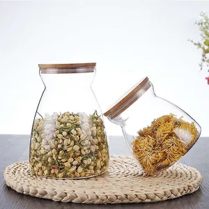 Detail view of trapezoidal glass storage jars with natural bamboo lids for flower tea