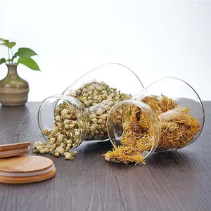 Macro view of transparent trapezoidal glass storage jars with bamboo lids and dried flowers