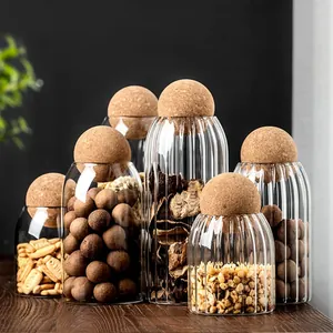 Set of ribbed glass storage jars with round cork ball lids for kitchen pantry organization