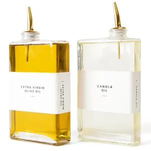 Modern set of two 350ml square glass oil dispenser bottles with elegant gold pour spouts