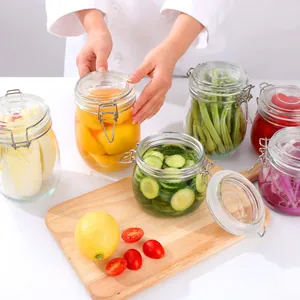 Detail of hermetic glass storage jars with clip lids filled with colorful pickled vegetables