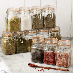 Set of small airtight glass spice jars with orange seals for kitchen storage
