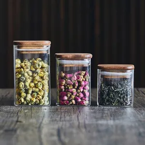 Set of three square glass storage jars with airtight acacia wood lids for tea and herbs