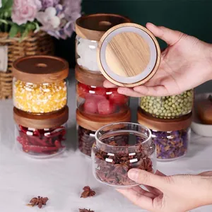 Detailansicht eines transparenten Glas-Vorratsglases mit Deckel aus Akazienholz