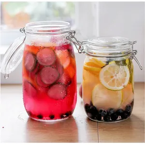 Detailed view of two glass storage jars with airtight clamp lids and colorful fruit infused water