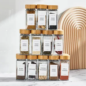 Pyramid stack of minimalist square glass spice jars with bamboo lids and spice labels