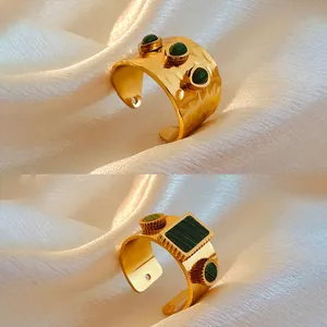 Detailed view of vintage 18K gold-plated stainless steel rings with green natural stones.