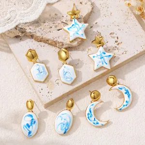 Blue and white marble pattern earrings in star, moon, and geometric shapes with gold finish