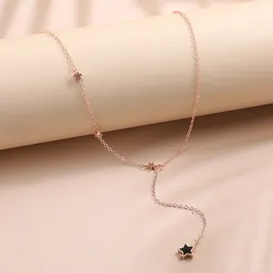 Minimalist rose gold star necklace with black enamel charm, dainty lariat style chain