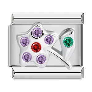 Detailed macro view of silver stainless steel charm featuring a multi-color zircon flower