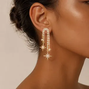 Close-up of 18K gold plated long dangling chain earrings with eight-pointed stars