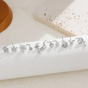 Macro view of assorted silver titanium steel ear studs with sparkling cubic zirconia stones