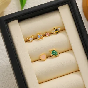 Set of 18K gold plated stud earrings featuring bee and turtle designs in a display box
