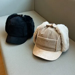 Detailed view of corduroy trapper hats with plush faux fur ear protection flaps
