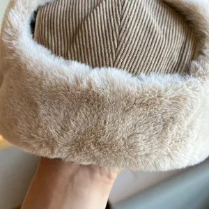 Close-up detail of corduroy texture and plush faux fur on a warm winter trooper hat.