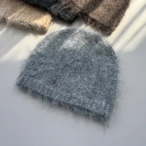 Detailed view of a grey fluffy mohair-style beanie hat with soft and warm knit texture