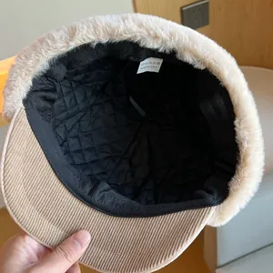 Inside detail of corduroy winter trapper hat with soft plush lining and wash tag