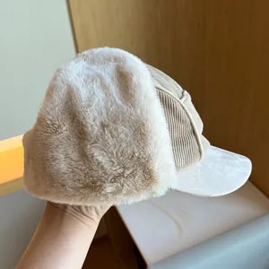 Close-up detail of a warm winter earflap hat featuring corduroy fabric and soft plush lining