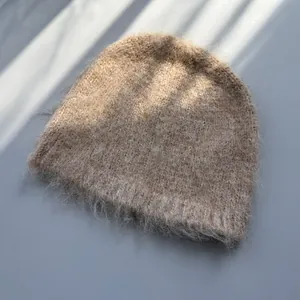 Macro detail shot of camel fluffy knit beanie showing soft, warm, fuzzy texture
