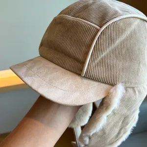 Close-up of beige corduroy Lei Feng hat with warm faux fur lining for winter