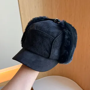 Close-up of black corduroy trapper hat with thick plush earflaps for winter warmth