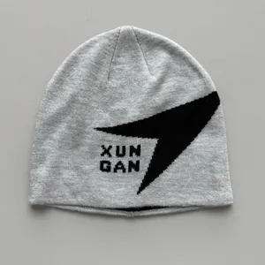 Primer plano de un gorro de punto gris con diseño gráfico negro XUN GAN para el deporte.