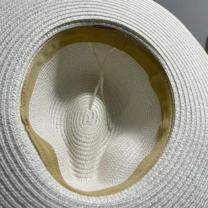 Internal detail of a white Panama straw hat showing the woven texture and sweatband.