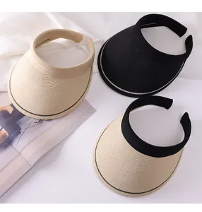 Detail view of stylish woven straw sun visors in black and beige headband styles for women