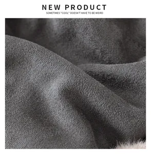 Macro detail view showing the soft grey faux suede texture of a warm winter trapper hat