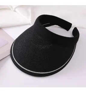 Close-up view of a black woven straw sun visor featuring a white stripe detail on the brim edge