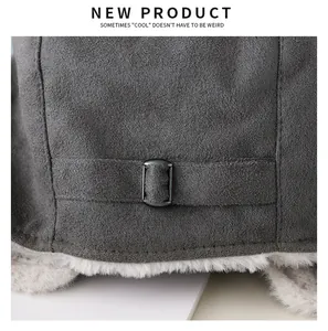 Close-up of grey trapper hat with metal buckle and soft plush lining detail