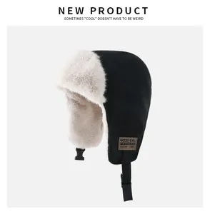 Close-up detail of a black trapper hat with warm beige faux fur lining and chin strap