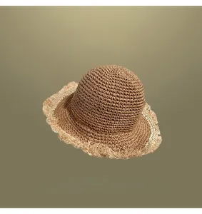 Elegant hand-woven straw sun hat for women with frayed edge detail for summer beach trips