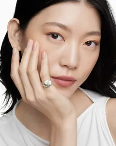 Detail shot of a silver textured ring with minimalist twill pattern on Asian model.