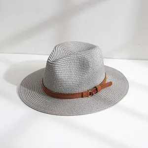 Détail d'un chapeau de paille Panama gris tressé avec une élégante sangle de ceinture brune