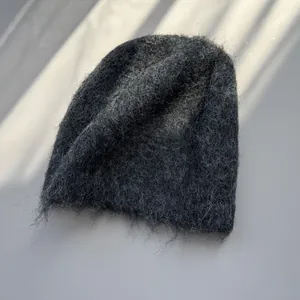 Close-up of soft charcoal grey fuzzy mohair beanie with warm winter knit texture