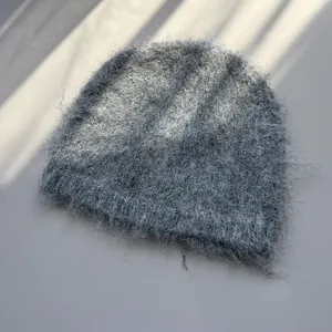Stylish grey fluffy knit beanie hat with fuzzy texture for winter warmth and comfort