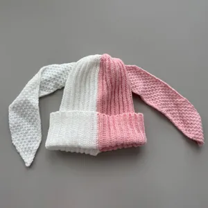Close-up top view of the two-tone pink and white knitted texture and bunny ear design