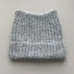 Detailed view of the chunky rib-knit texture and cute cat ear design of the gray beanie.